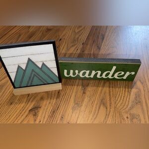 Green 'Wander' Sign and Mountain Art
